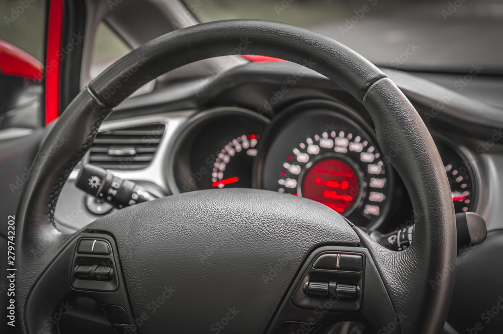 Fototapeta premium Car interior with steering wheel and dashboard