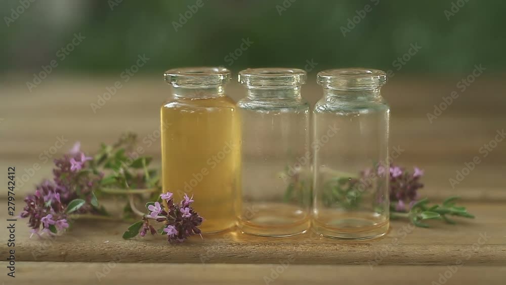 thyme essential oil in beautiful bottle on table thyme essential oil in beautiful bottle on table