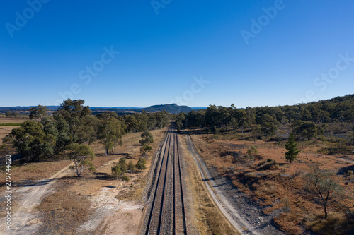Railway tracks heading into the Australian outback.