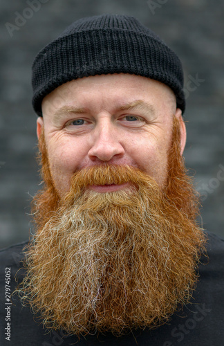 Cute charismatic redhead man with impish smile