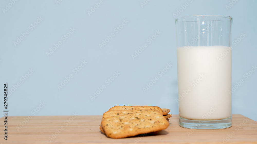 glass of milk and biscuits on wooden table glass of milk and biscuits on wooden table