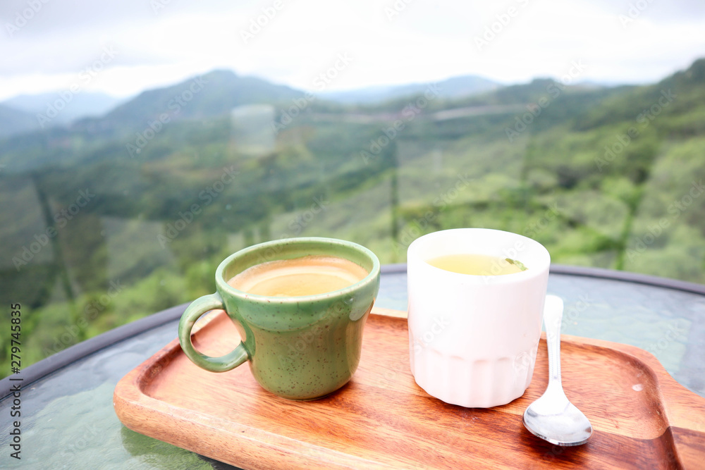 Cup of coffee and tea in the beautiful sky of mountains,traveling on holiday concept .
