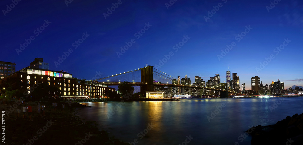 New York City downtown skyline and Brooklyn bridge at sunset
