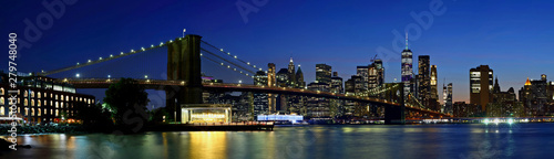 Panorama New York City downtown skyline and Brooklyn bridge at sunset