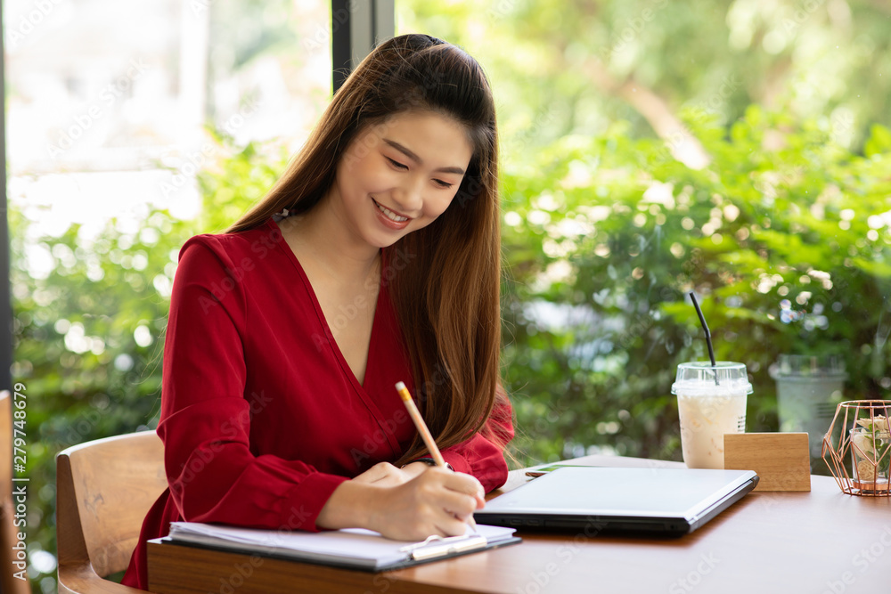 Beautiful Attractive Asian woman working with laptop smile and writing idea and requirement for success job outside office in coffee shop,Business Concept,Warm Tone Beautiful Attractive Asian woman working with laptop smile and writing idea and requirement for success job outside office in coffee shop,Business Concept,Warm Tone