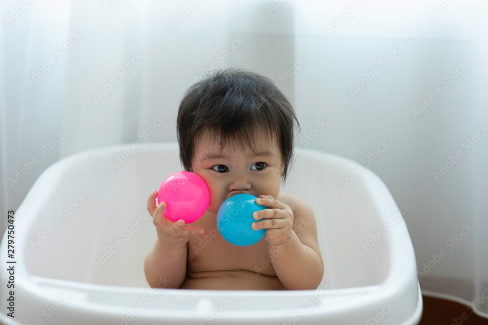 Cute Sweet Adorable Asian Baby Sitting on bathtub with plastic balls smiling and playing with happiness emotional in cozy bedroom,Healthy Baby Concept Cute Sweet Adorable Asian Baby Sitting on bathtub with plastic balls smiling and playing with happiness emotional in cozy bedroom,Healthy Baby Concept
