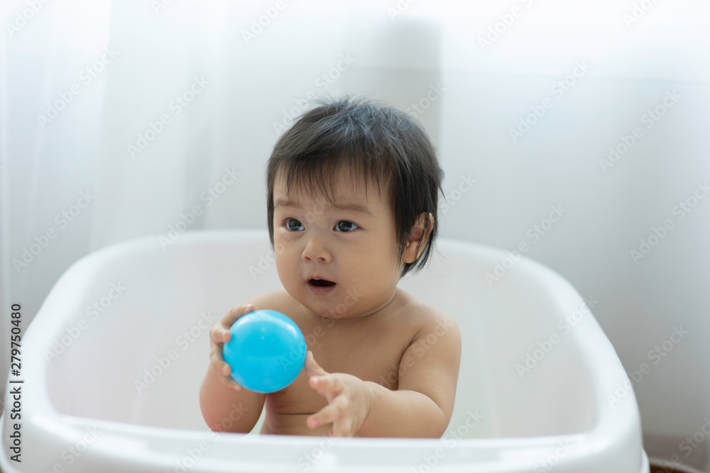 Cute Sweet Adorable Asian Baby Sitting on bathtub with plastic balls smiling and playing with happiness emotional in cozy bedroom,Healthy Baby Concept Cute Sweet Adorable Asian Baby Sitting on bathtub with plastic balls smiling and playing with happiness emotional in cozy bedroom,Healthy Baby Concept
