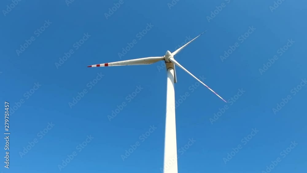 slowly rotating blades of a windmill propeller. Wind power generation. Pure green energy slowly rotating blades of a windmill propeller. Wind power generation. Pure green energy