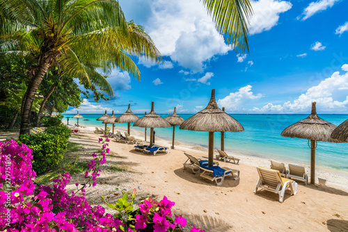 Fotografie, Obraz Public beach with lounge chairs and umbrellas in Pointe aux Canonniers, Mauritiu