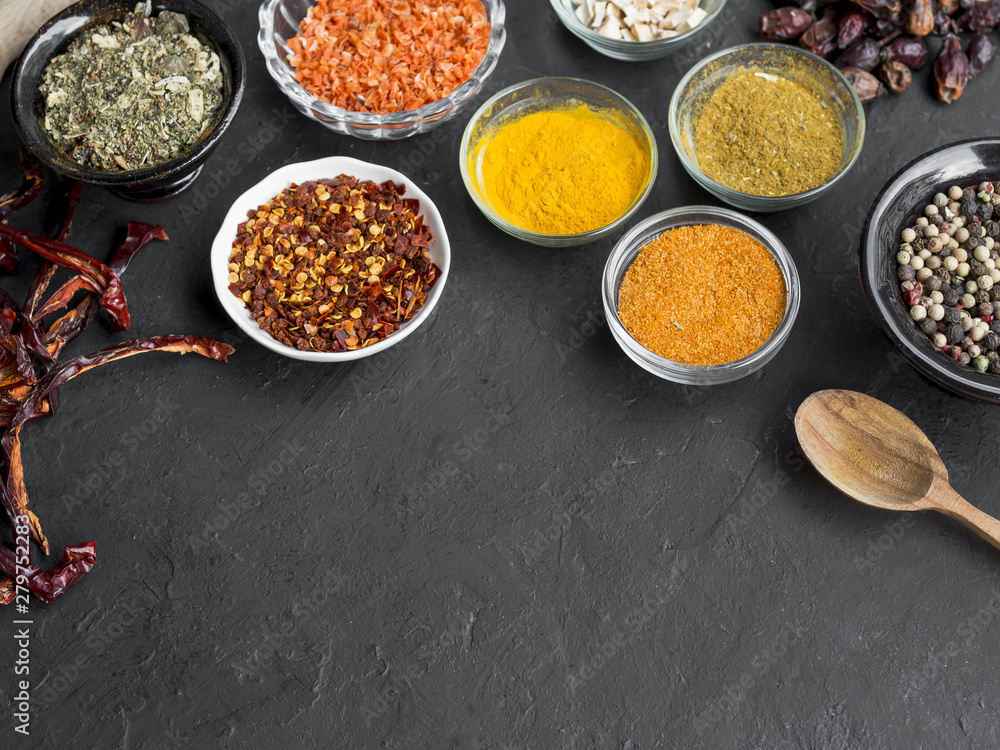 Group of bowls full of spices on black background Group of bowls full of spices on black background