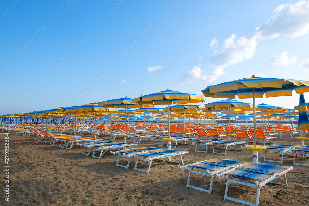 Umbrellas and sun loungers on the beach in the Adriatic. Romagna Riviera in Italy