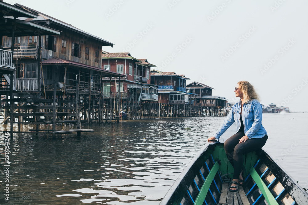 Caucasian blonde woman having a boat ride on Inle lake, Myanmar