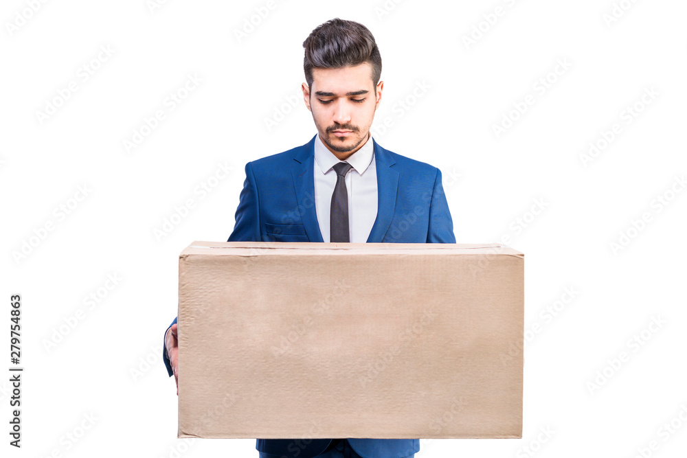 Attractive young man in a blue suit holding a cardboard box in his hands. Attractive young man in a blue suit holding a cardboard box in his hands.