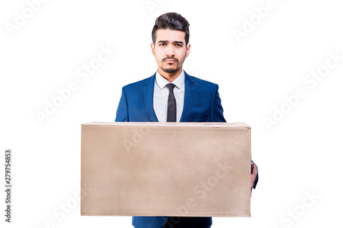 Attractive serious man in a blue suit holding a cardboard box in his hands