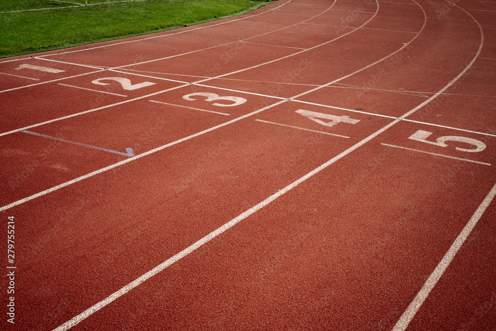 Sport. A red treadmill or athletics track with numner of line at the stadium. Copy space