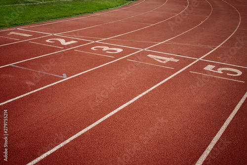 Sport. A red treadmill or athletics track with numner of line at the stadium. Copy space