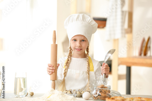 Cute little chef cooking in...