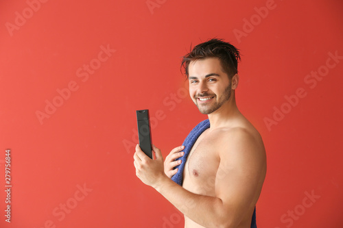 Handsome man with bottle of...