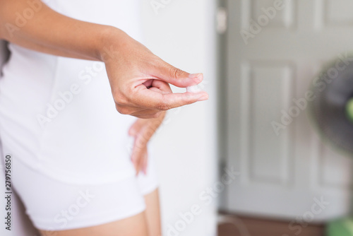 фотографія Woman finger holding with leucorrhoea and pain in abdomen or discharge with foul