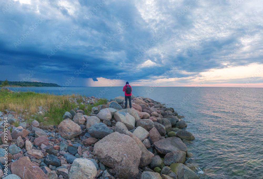 Fototapeta premium man at sunset by the sea.
