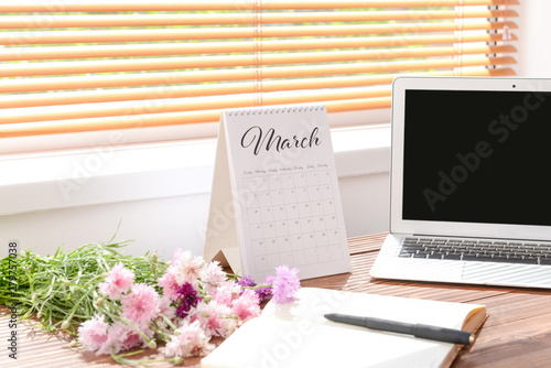 Calendar with laptop, flowe...