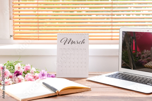 Calendar with laptop, flowe...