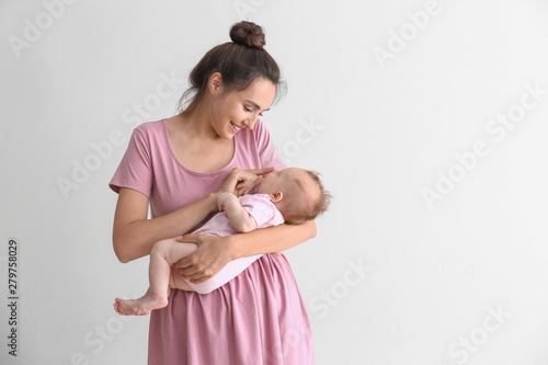 Happy mother with cute litt...