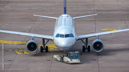 Aircraft is pushed backwards over the roll rock with an aircraft tractor