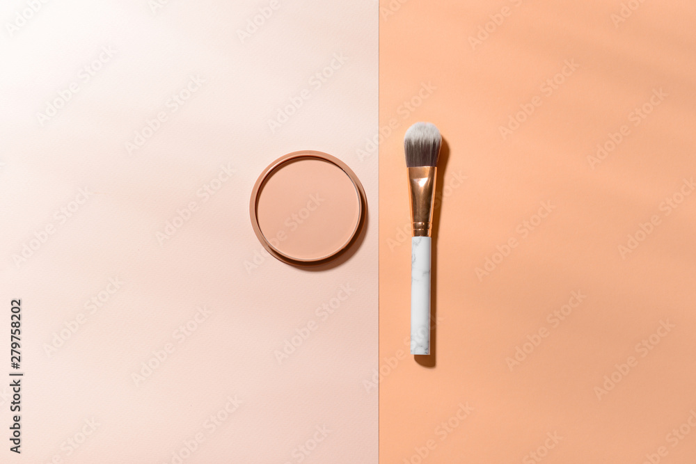 Makeup brush with facial powder on color background