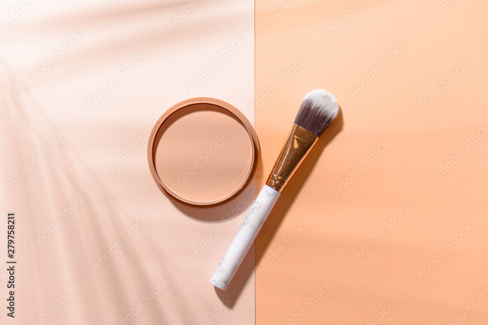 Makeup brush with facial powder on color background Makeup brush with facial powder on color background