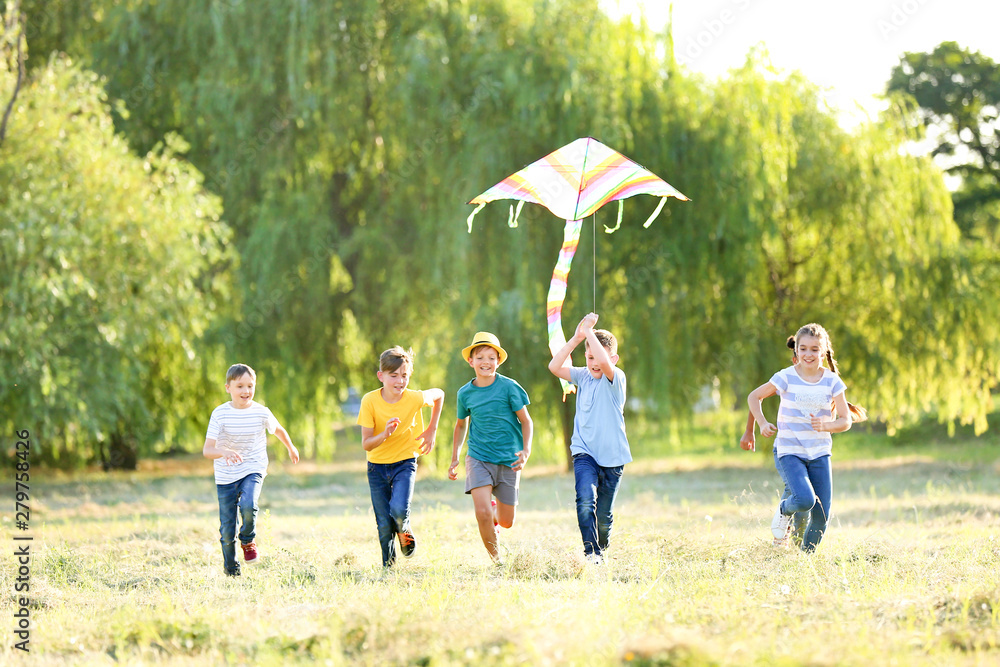 Obraz premium Children flying kite on summer day
