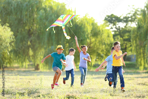Children flying kite on summer day
