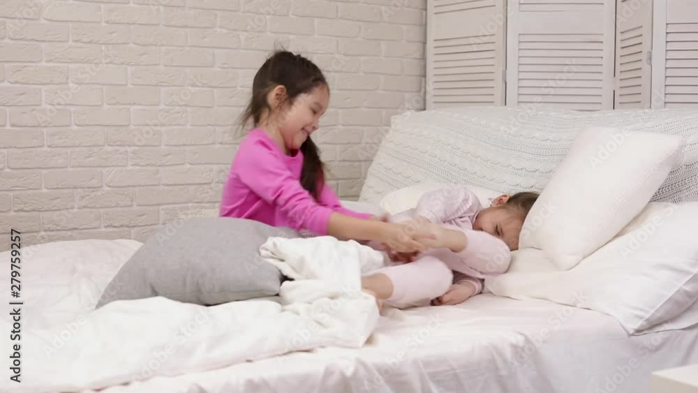 two cute children girls playing in the bedroom. pajama party and friendship. two cute children girls playing in the bedroom. pajama party and friendship.