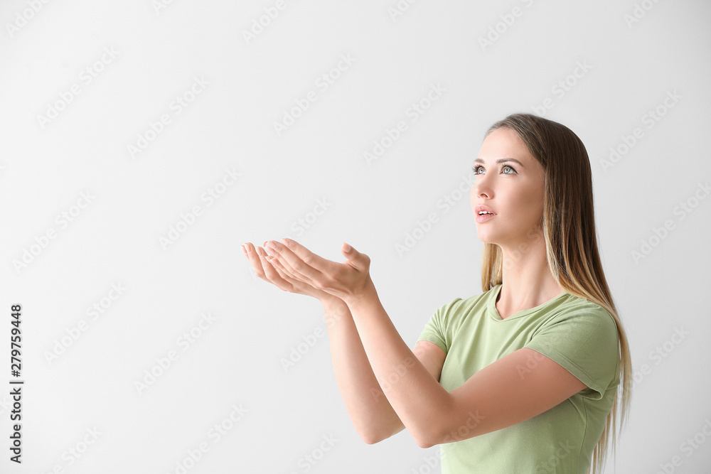 Religious young woman praying on white background Religious young woman praying on white background