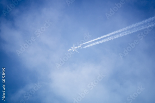blue sky with plane in the clouds