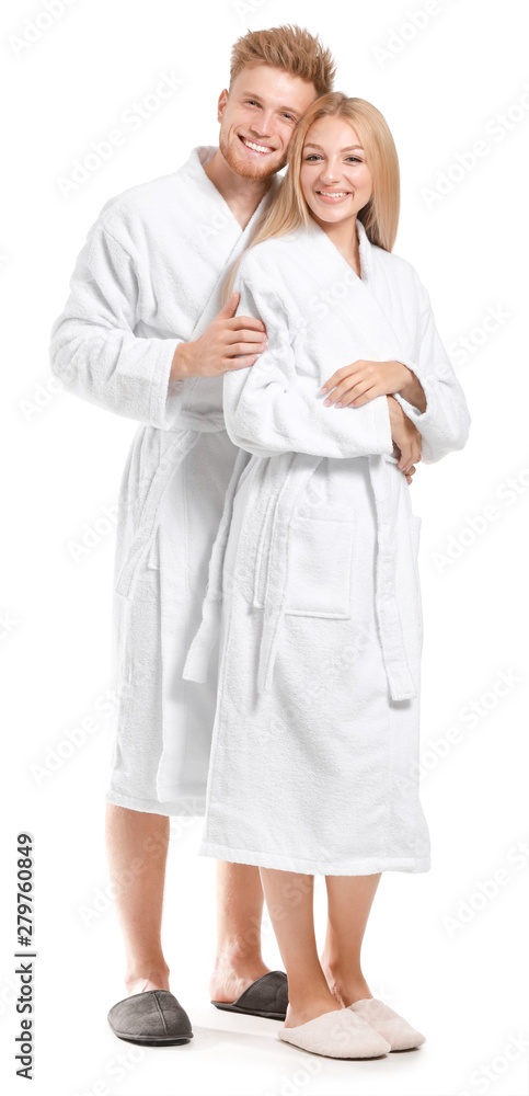 Happy young couple in bathrobes on white background Happy young couple in bathrobes on white background