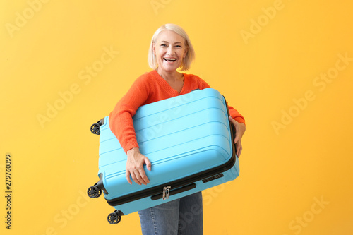 Mature woman with suitcase ...