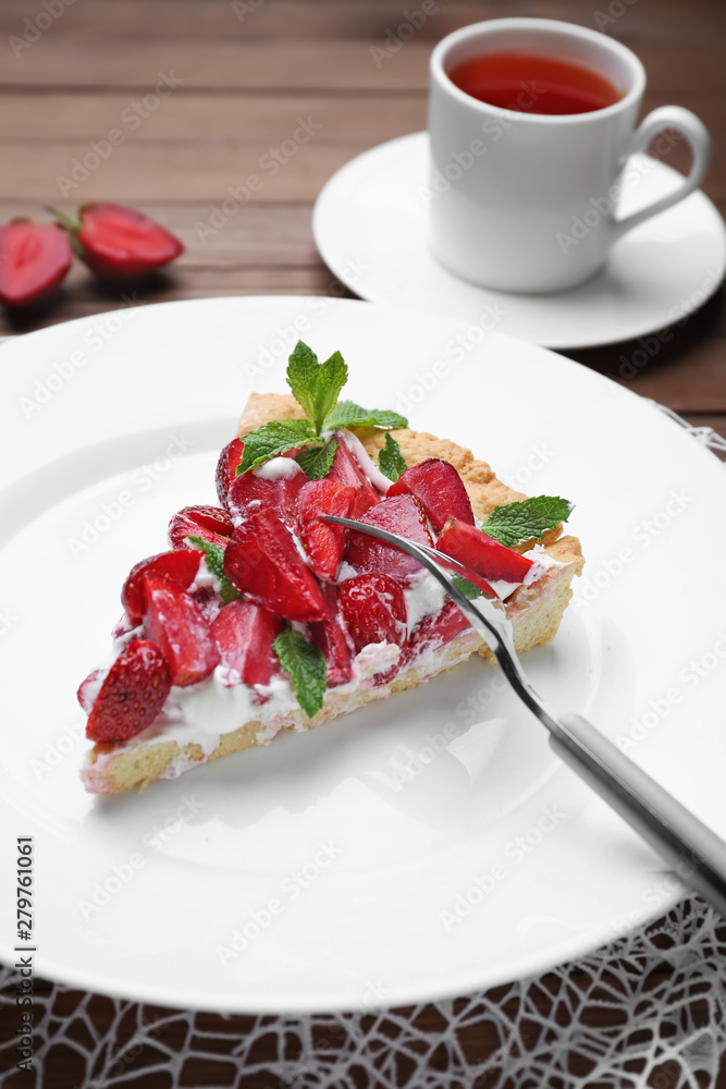 Plate with piece of tasty strawberry cake on table Plate with piece of tasty strawberry cake on table