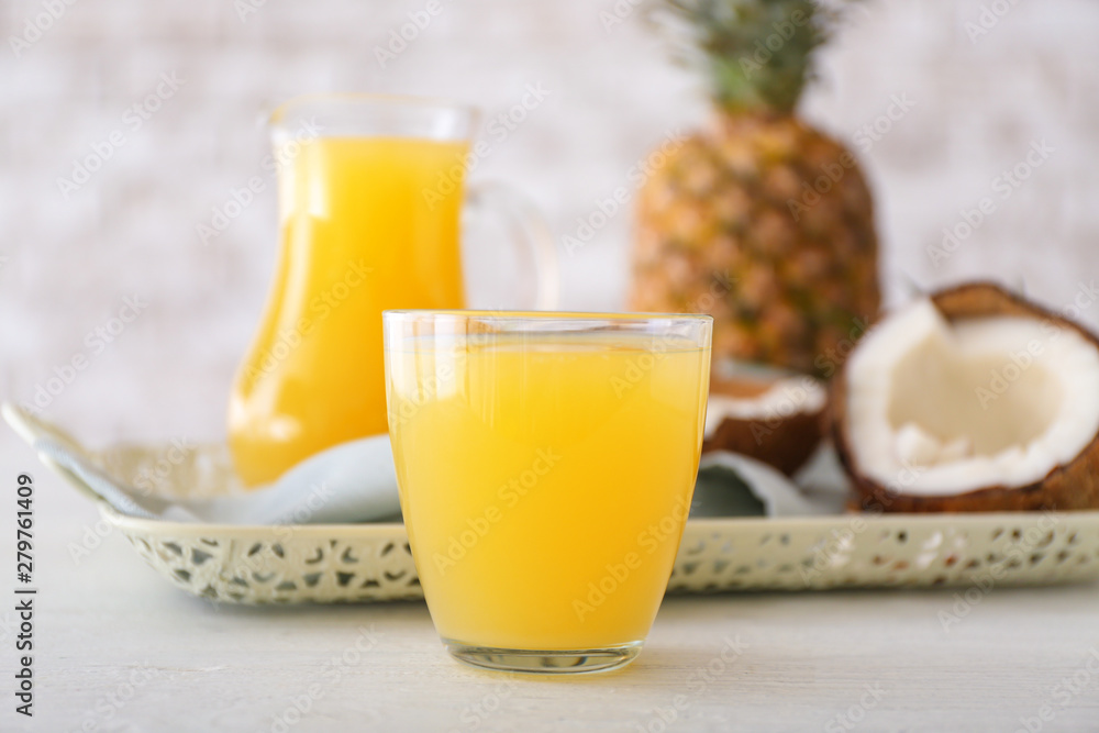 Glass of fresh pineapple juice on table Glass of fresh pineapple juice on table