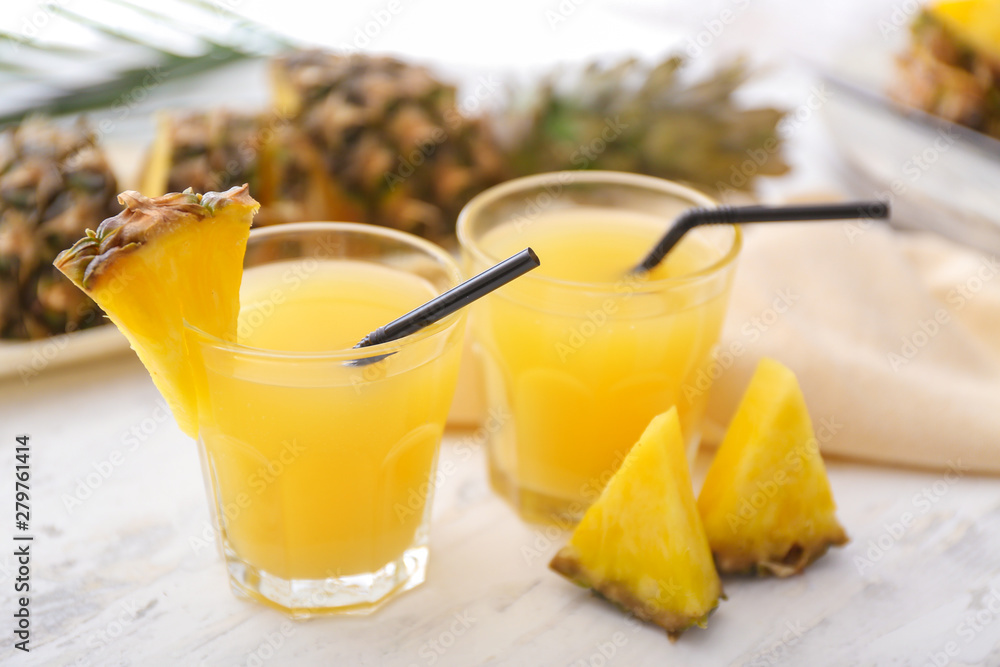 Glasses of fresh pineapple juice on table Glasses of fresh pineapple juice on table