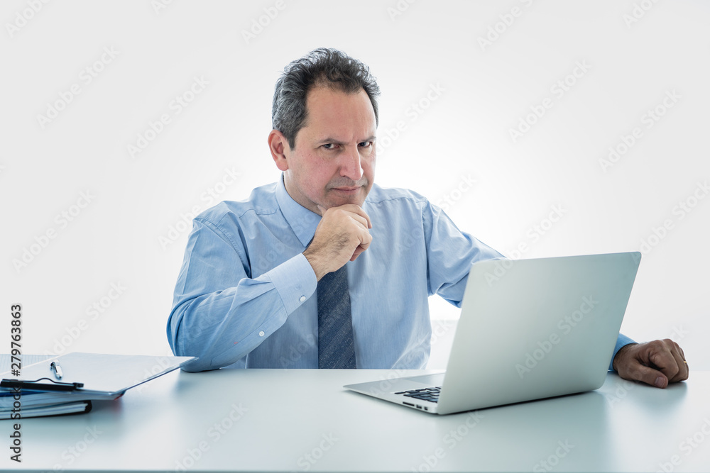 Overwhelmed and tired mature businessman working at office feeling stressed and headache Overwhelmed and tired mature businessman working at office feeling stressed and headache