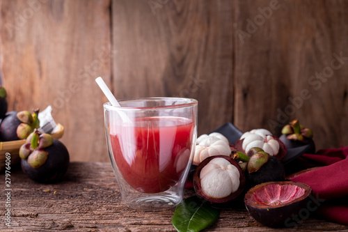 kitchen table with glass of fresh mangosteen juice.