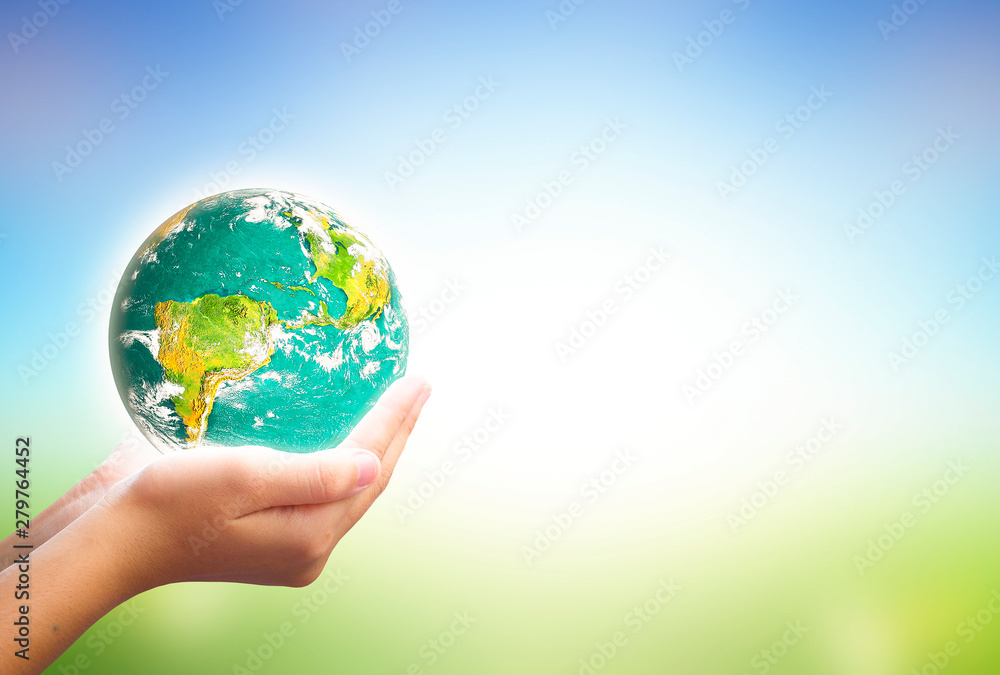 Earth day concept: Human hands holding earth global over nature background Earth day concept: Human hands holding earth global over nature background