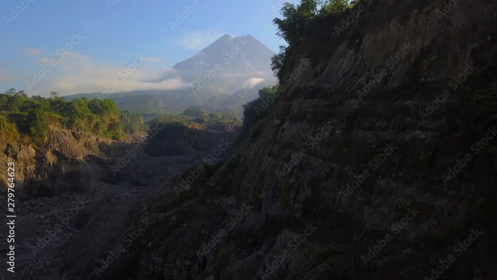 Untitled ProjectAerial: Drone flies at canyon with open view on the volcano Merapi, Java island, Indonesia Untitled ProjectAerial: Drone flies at canyon with open view on the volcano Merapi, Java island, Indonesia