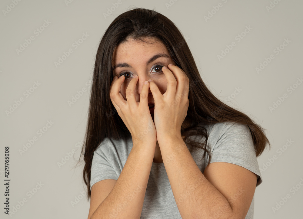 Portrait of a young attractive woman looking scared and shocked. Human expressions and emotions Portrait of a young attractive woman looking scared and shocked. Human expressions and emotions