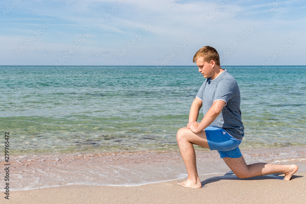 Handsome Man Exercising At Beach, Training Outdoor. Sports And Fitness Concept Handsome Man Exercising At Beach, Training Outdoor. Sports And Fitness Concept