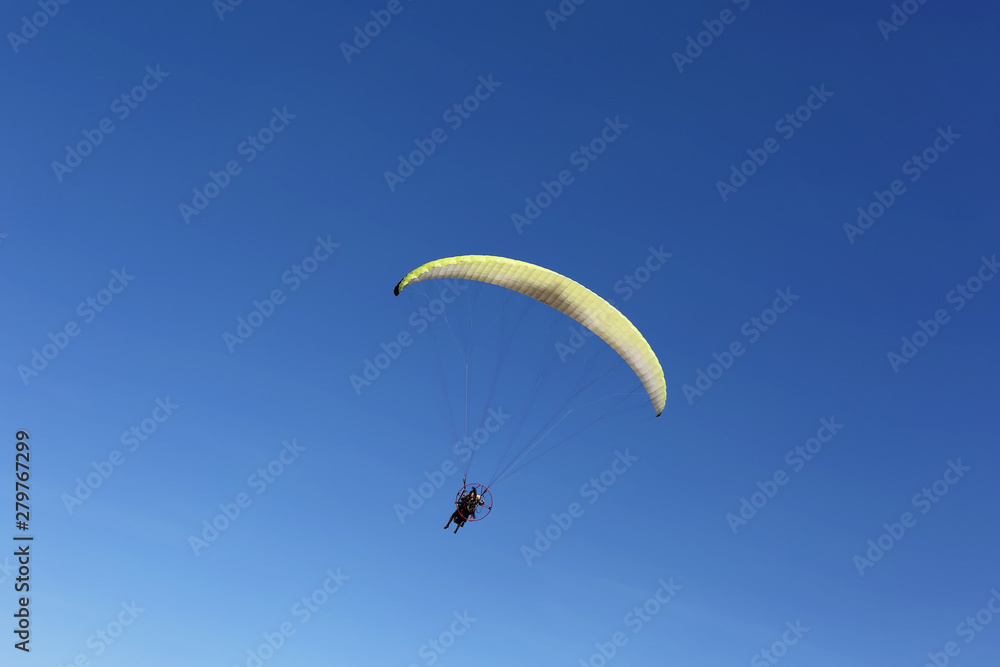 Man fly over blue sky as paragliding extreme sport Man fly over blue sky as paragliding extreme sport