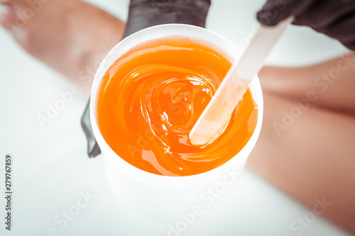 Obraz na plátně Concentrated beauty salon worker choosing sugar mixture