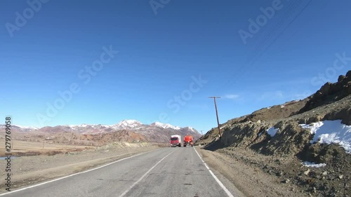 Driving along mountain asphalt road Chuysky Tract along Kurai Ridge on Altai betveen Kosh-Agach and Kurai intermountain hollows photo