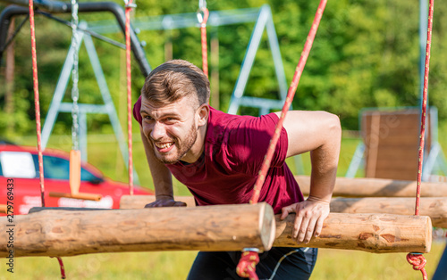Extreme obstacles overcome by runner in the boot camp